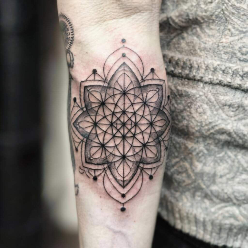 A tattoo on a person's arm, geometric tattoo style