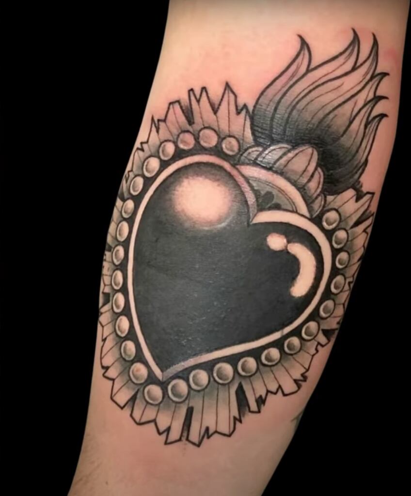 Sacred heart tattoo example for woman.